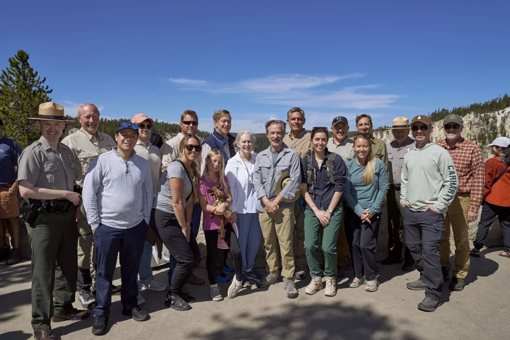 Senators, National Park Service staff, and conservation partners pose together overlooking the Yellowstone River canyon during PERC's 2026 Senate CODEL tour.